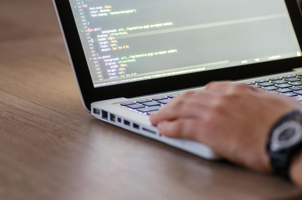 Person coding on laptop computer.
